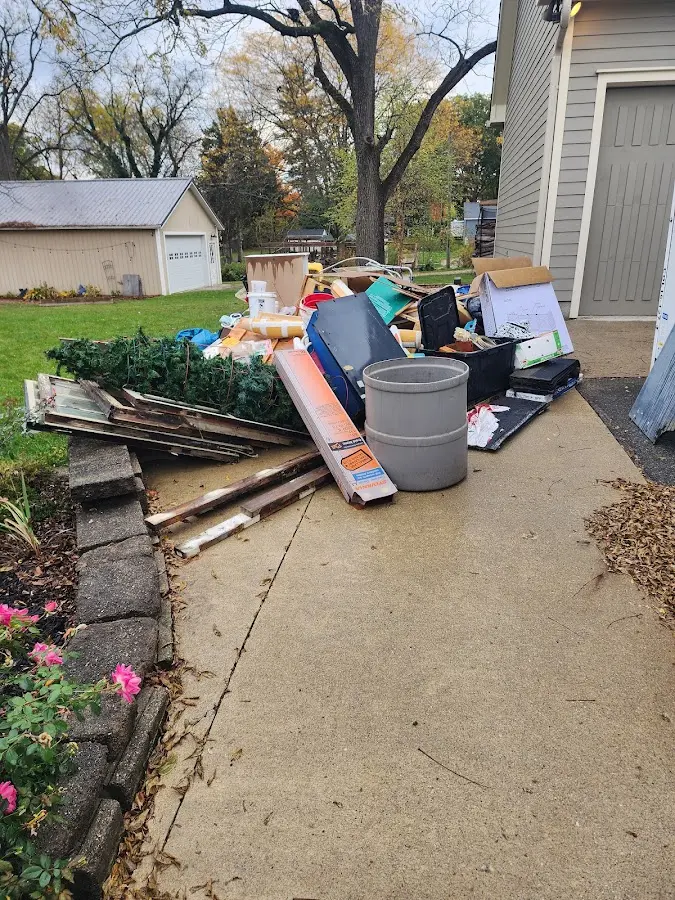 Dumpster being loaded with debris for 10 Yard Dumpster Rental in Orting